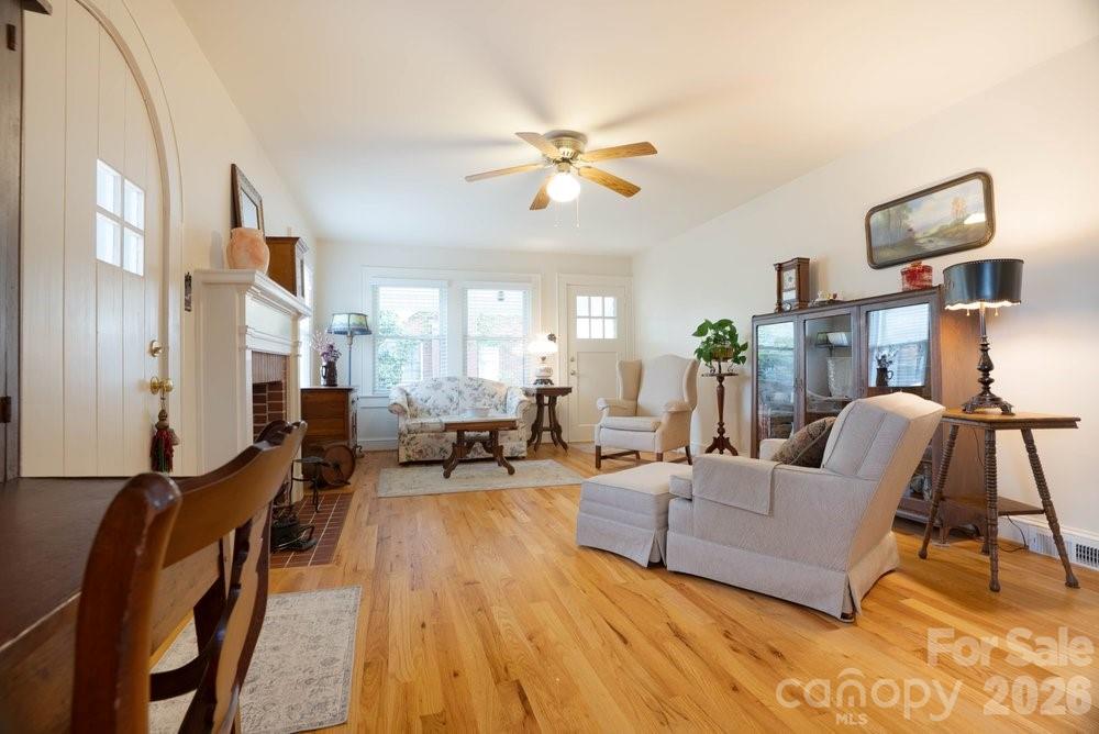 124 Rumple Street Troutman, NC 28166 - Photo 9 of 42 a living room with furniture and a chandelier