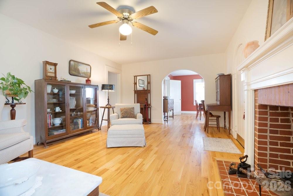 124 Rumple Street Troutman, NC 28166 - Photo 10 of 42 a living room with fireplace furniture and a wooden floor