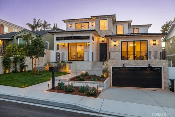 a front view of a house with a yard and a garage