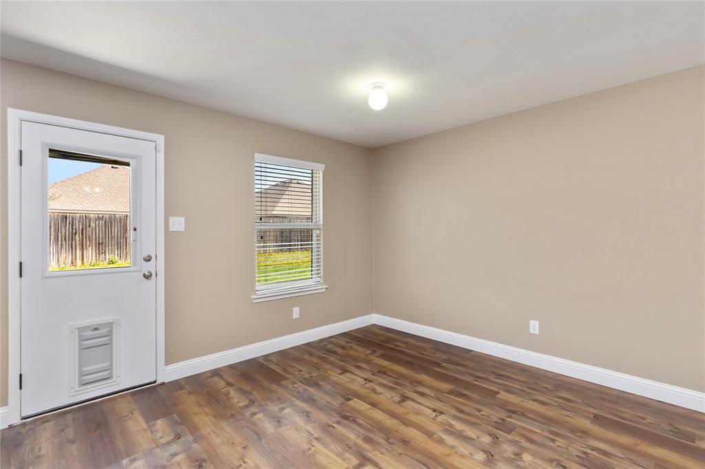 1450 Arabella Avenue Forney, TX 75126 - Photo 15 of 40 a view of an empty room with wooden floor and a window