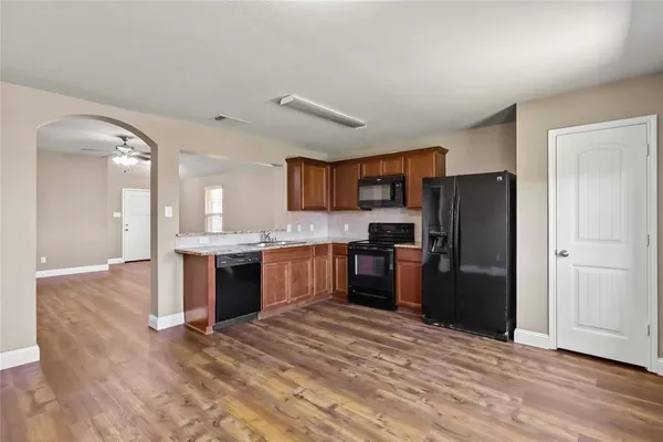 a kitchen with a refrigerator and a sink