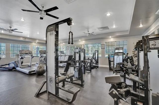 a kitchen with white cabinets and a window