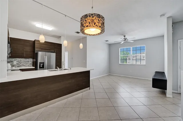 a view of kitchen with granite countertop cabinets and window