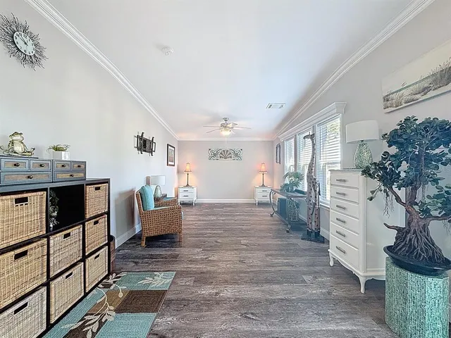 a living room with furniture and a dresser