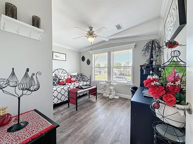 a living room with furniture and flowers