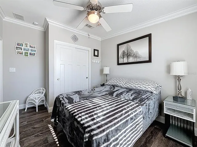 a bedroom with bed and a chandelier
