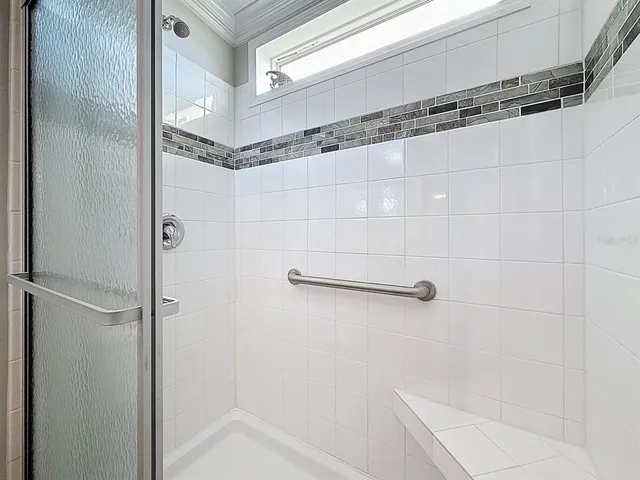 a bathroom with a shower and a sink