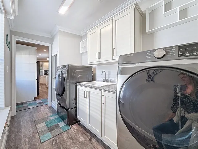a utility room with sink dryer and washer