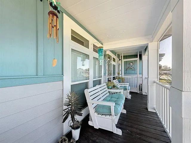 a balcony with chairs and wooden floor
