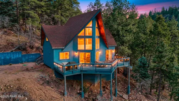 a view of swimming pool with a bench and lawn chairs under an umbrella