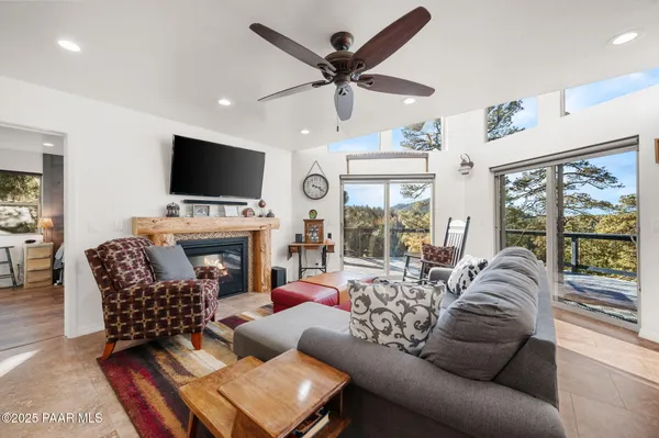 a view of a livingroom with furniture wooden floor and a clock