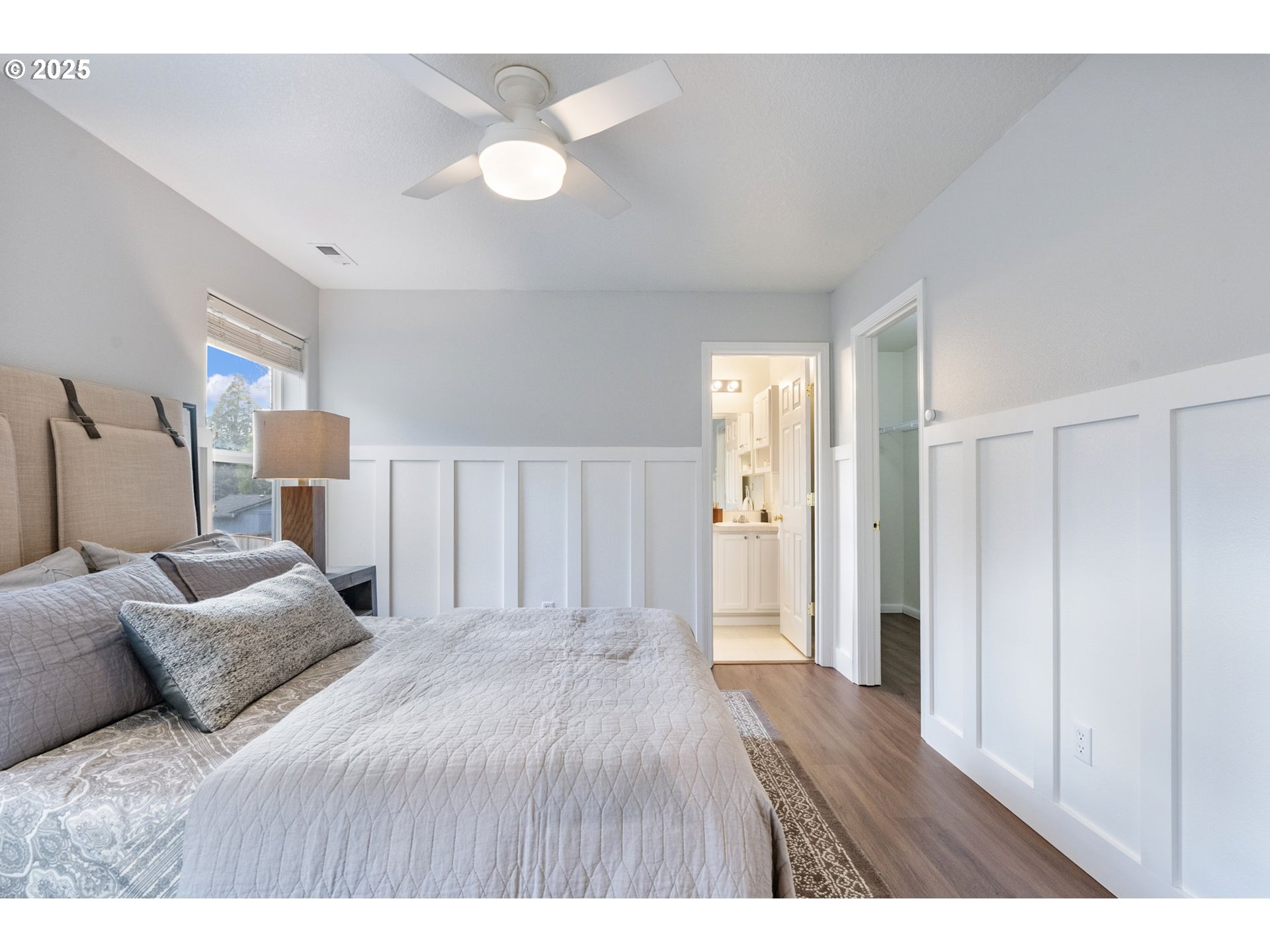 18186 Southwest Strathmoor Street Beaverton, OR 97007 - Photo 15 of 35 a spacious bedroom with a bed and a chandelier