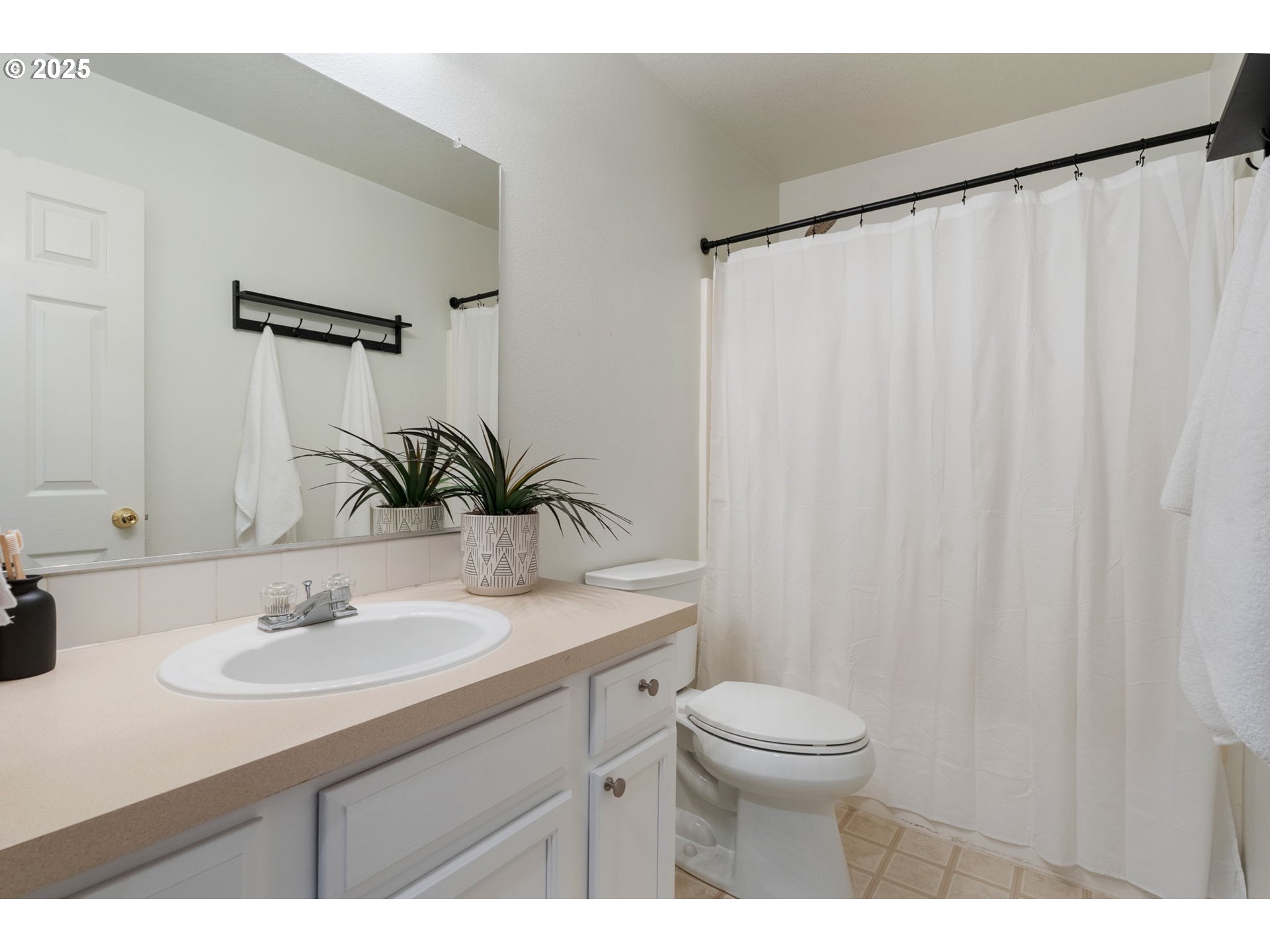 18186 Southwest Strathmoor Street Beaverton, OR 97007 - Photo 20 of 35 a bathroom with a sink and a mirror