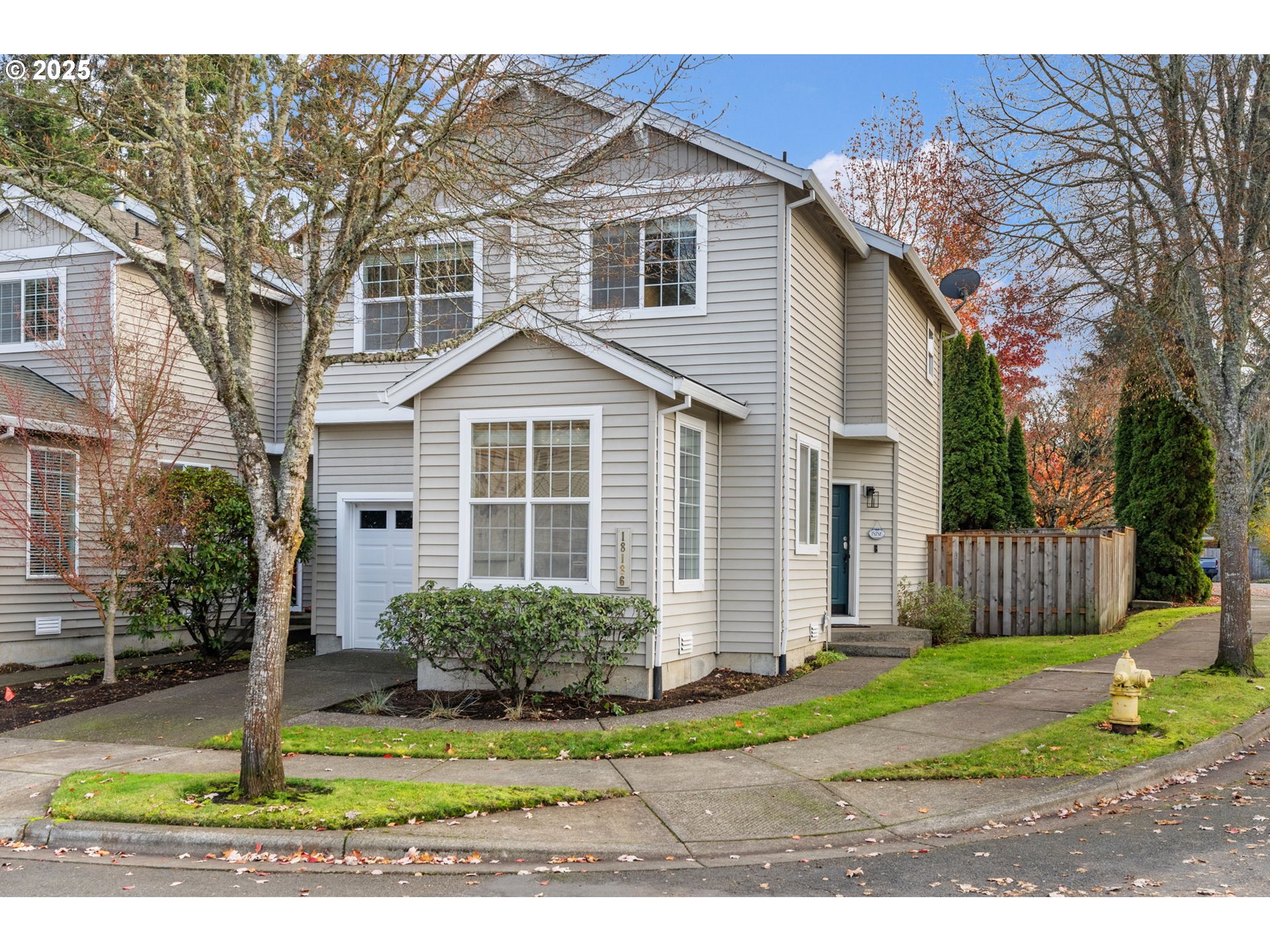 18186 Southwest Strathmoor Street Beaverton, OR 97007 - Photo 22 of 35 a front view of a house with a yard