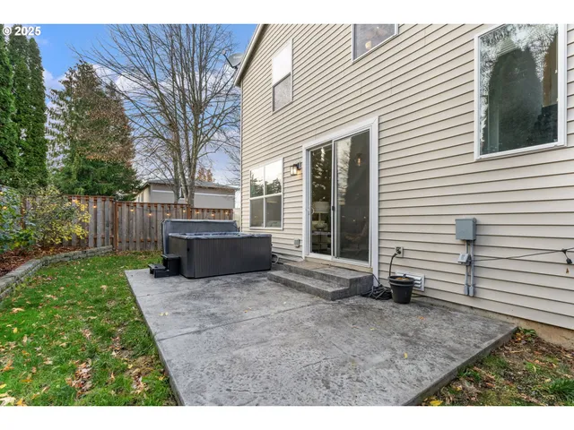 a view of a backyard with table and chairs and wooden fence
