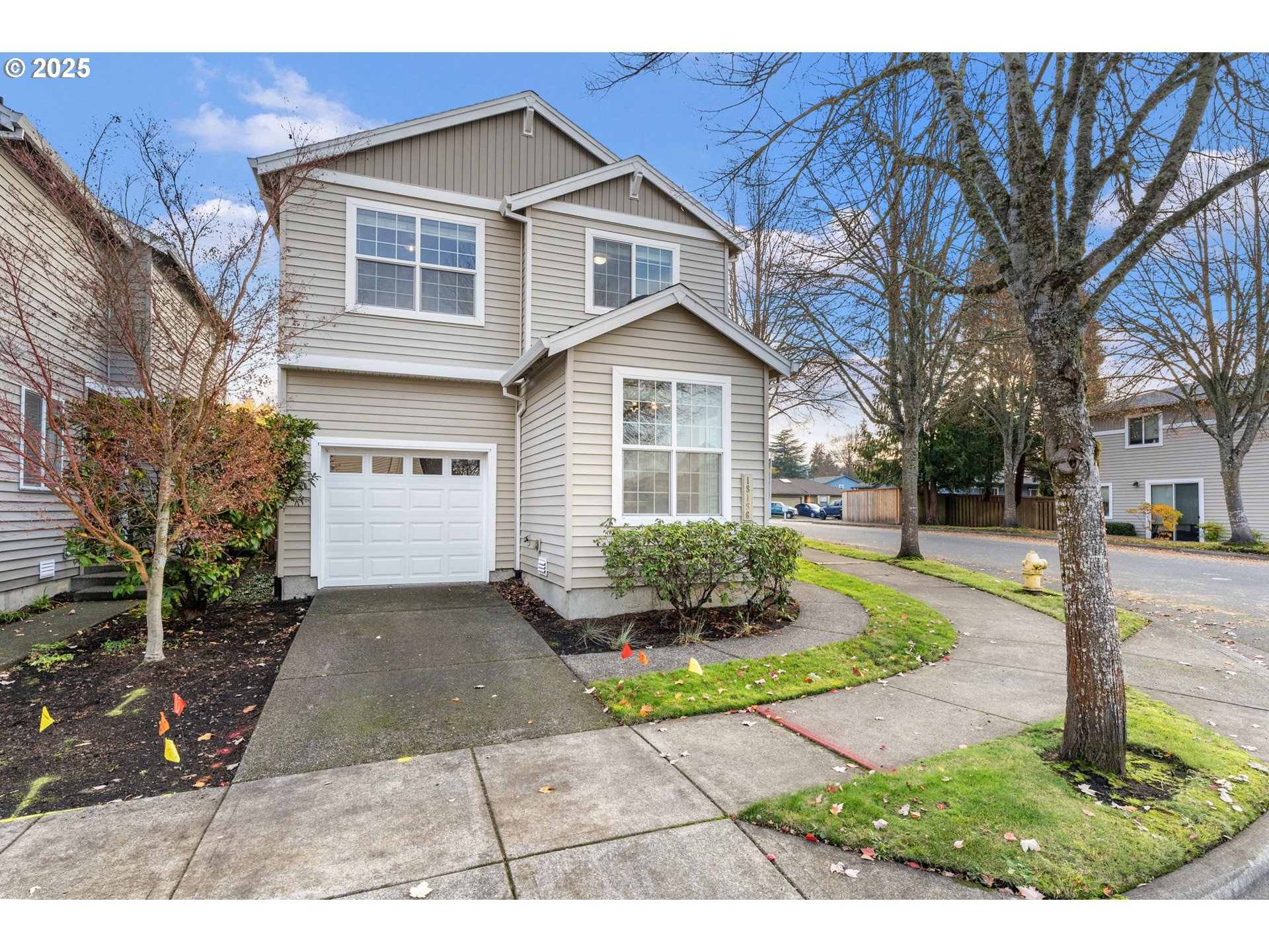 18186 Southwest Strathmoor Street Beaverton, OR 97007 - Photo 34 of 35 a front view of a house with a yard and potted plants