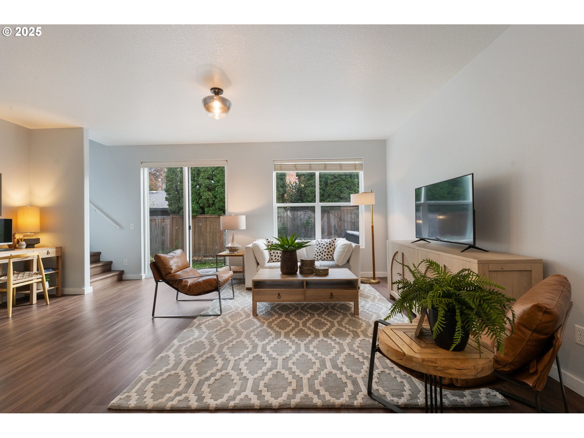18186 Southwest Strathmoor Street Beaverton, OR 97007 - Photo 5 of 35 a living room with furniture and a flat screen tv