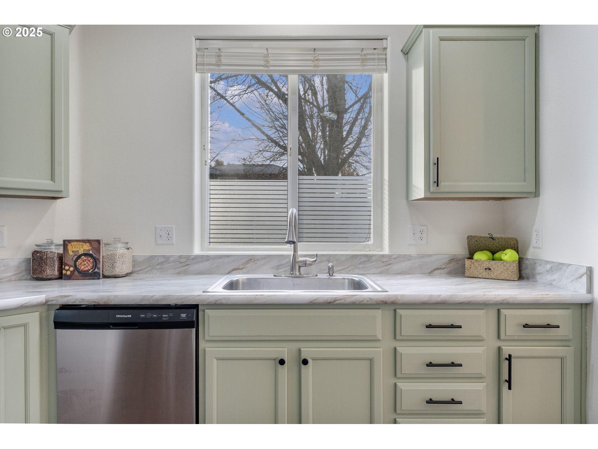 18186 Southwest Strathmoor Street Beaverton, OR 97007 - Photo 9 of 35 a kitchen with granite countertop a sink and a white cabinets