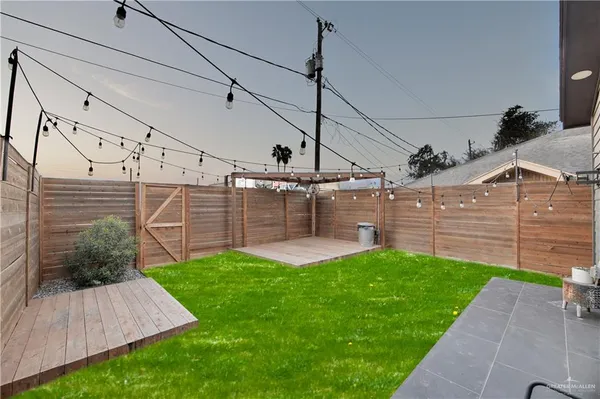a view of a backyard with plants and a patio