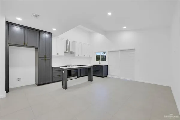 a room with stainless steel appliances kitchen island