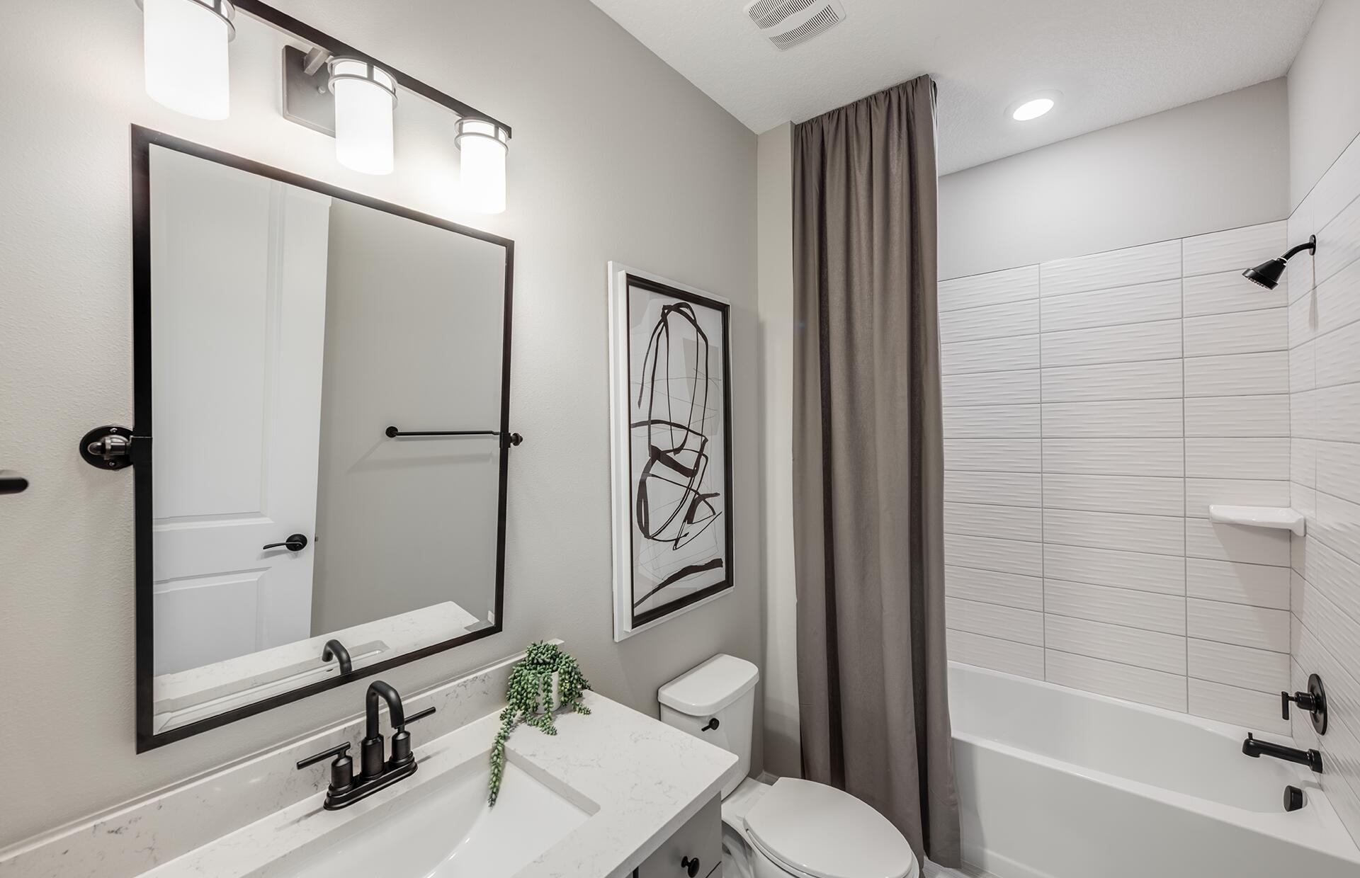 10231 Southwest Highpointe Drive, Unit ASHBY 281 Stuart, FL 34997 - Photo 16 of 33 a bathroom with a sink a toilet and shower