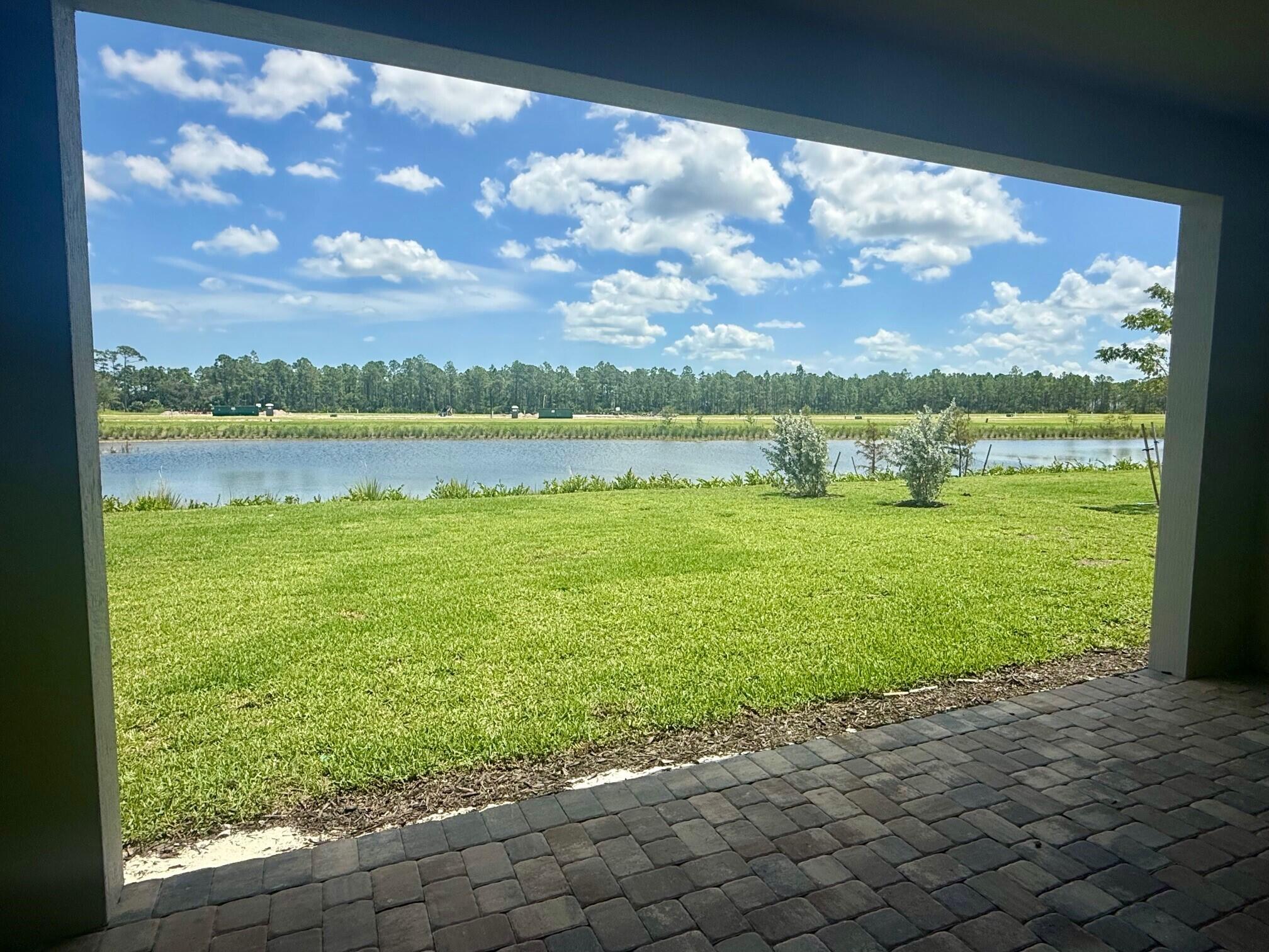 10231 Southwest Highpointe Drive, Unit ASHBY 281 Stuart, FL 34997 - Photo 3 of 33 a view of a lake with a big yard