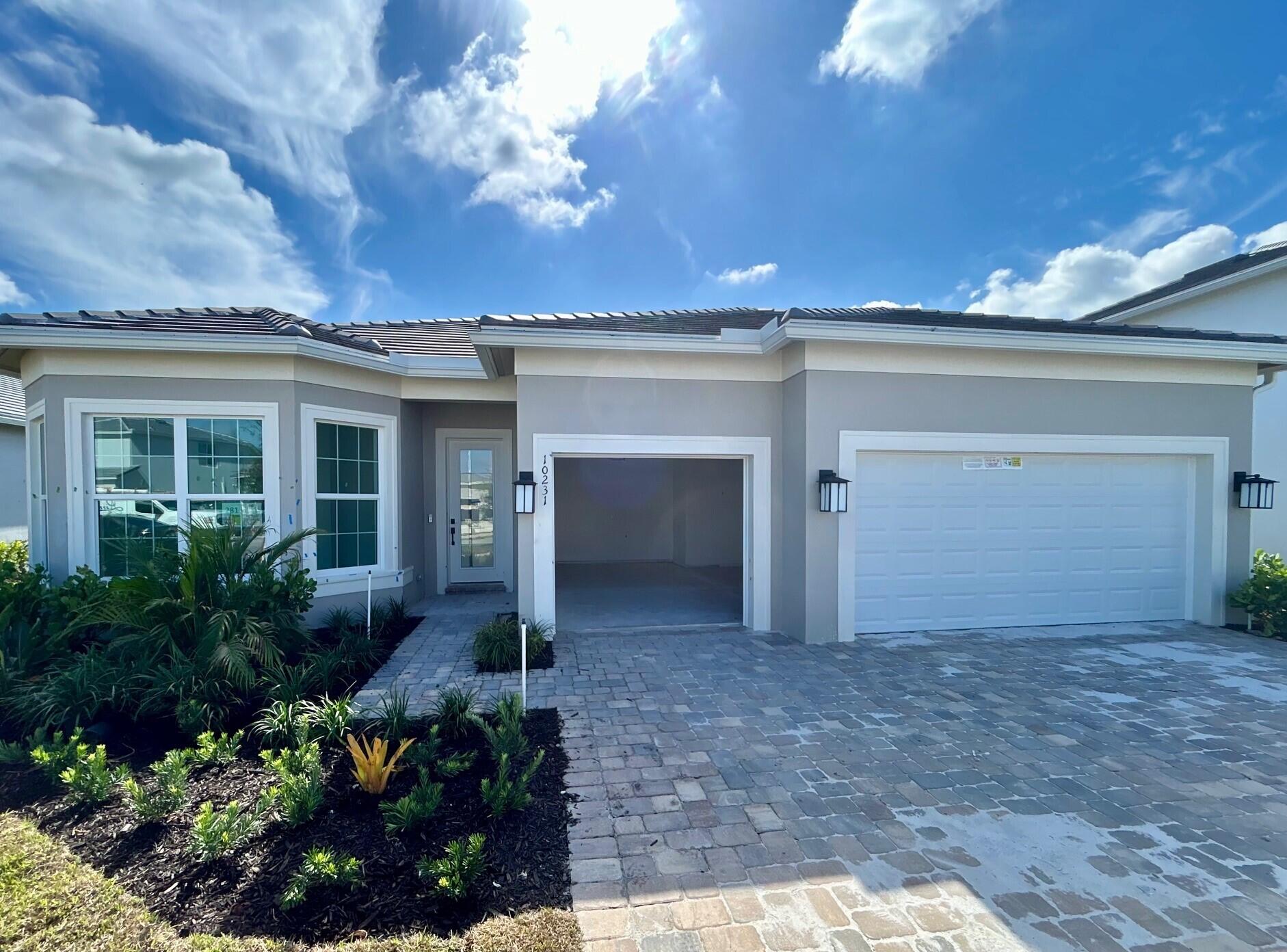 10231 Southwest Highpointe Drive, Unit ASHBY 281 Stuart, FL 34997 - Photo 4 of 33 front view of a house with a yard