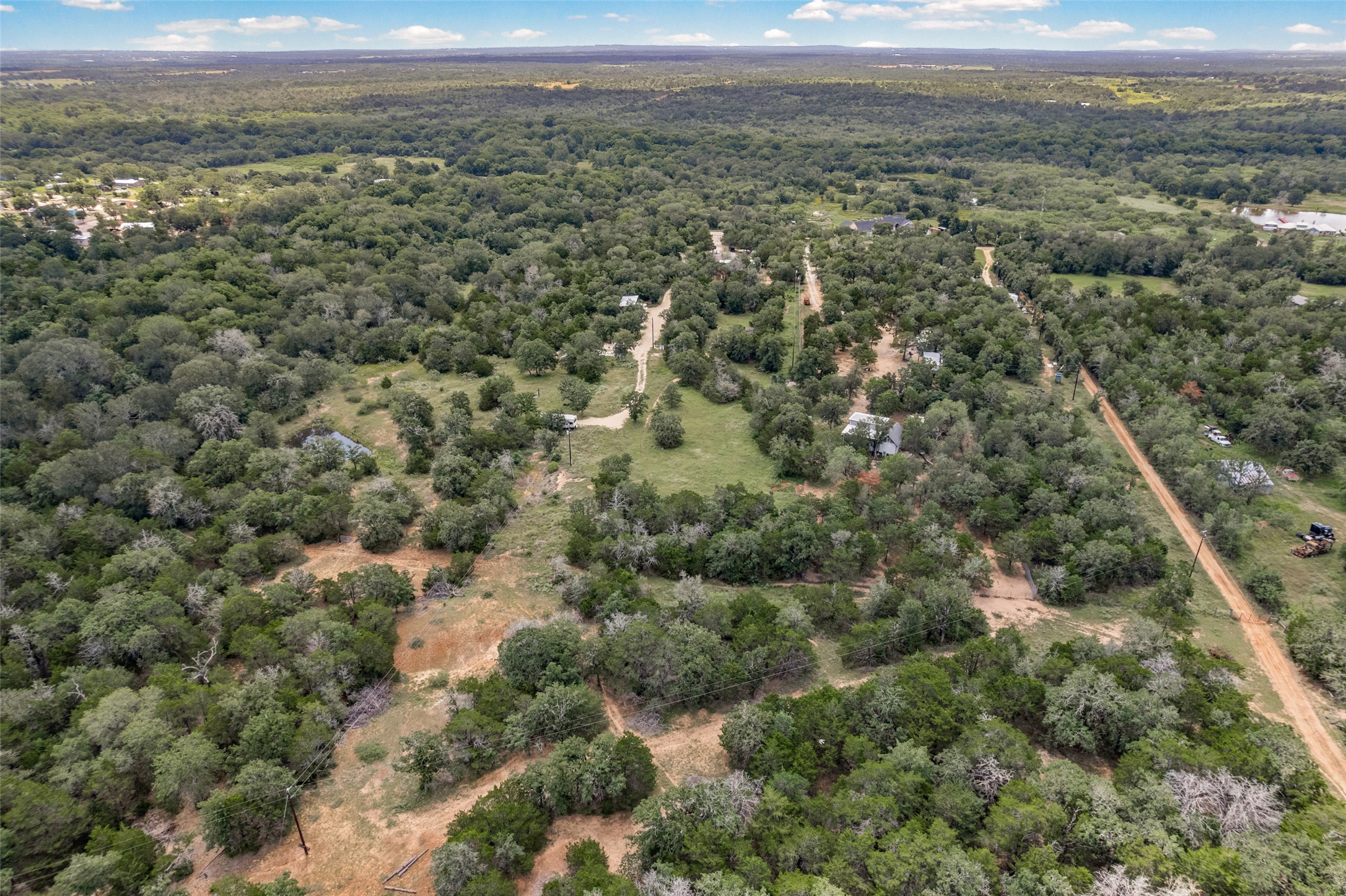 564 Boyd Road Red Rock, TX 78662 - Photo 2 of 25 Vast, verdant landscape with scattered dwellings offers secluded living.
