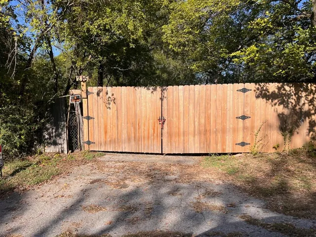 a view of a yard with large trees