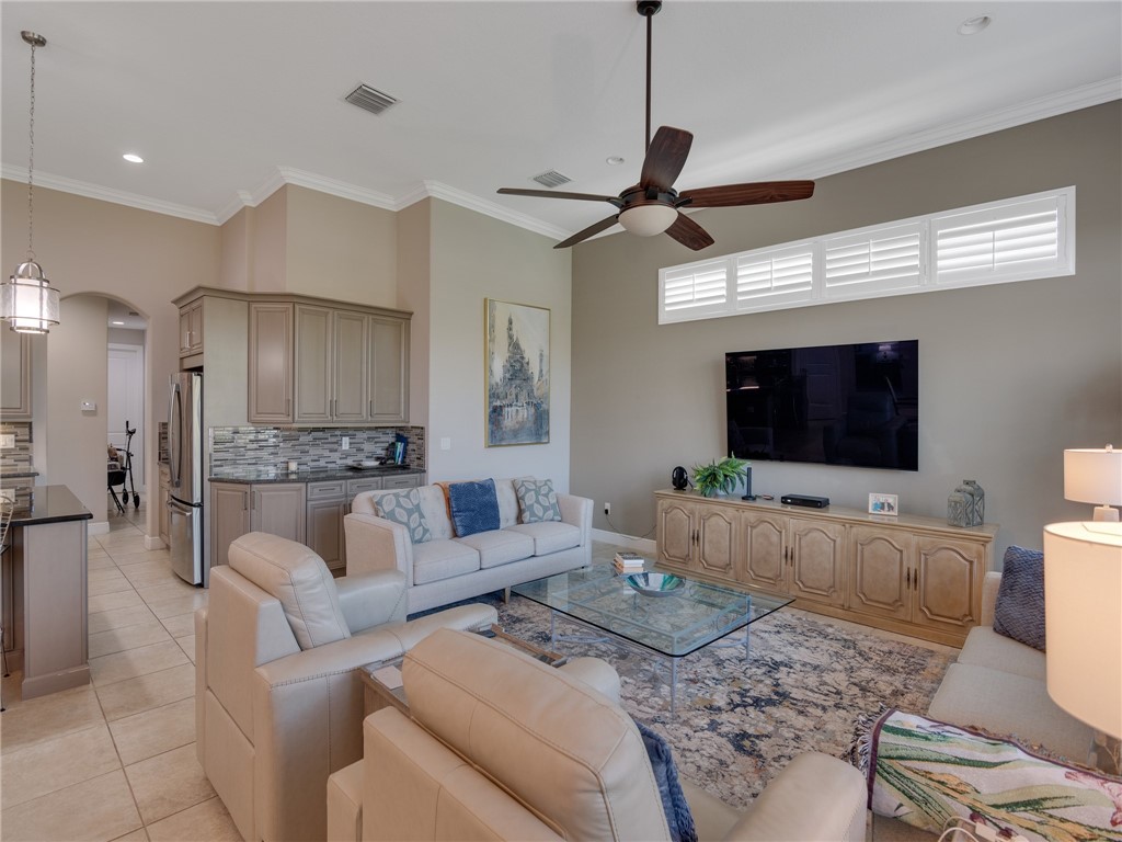 8260 Halbert Lane Vero Beach, FL 32968 - Photo 16 of 36 a living room with furniture and a flat screen tv