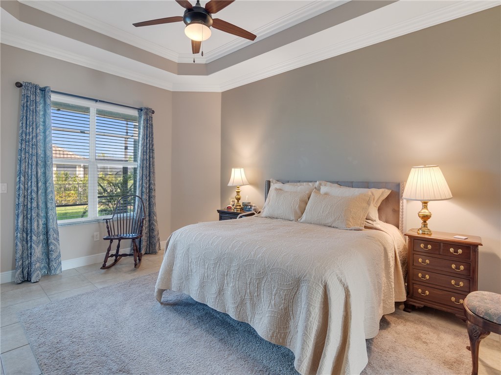 8260 Halbert Lane Vero Beach, FL 32968 - Photo 17 of 36 a bedroom with a bed and a chandelier