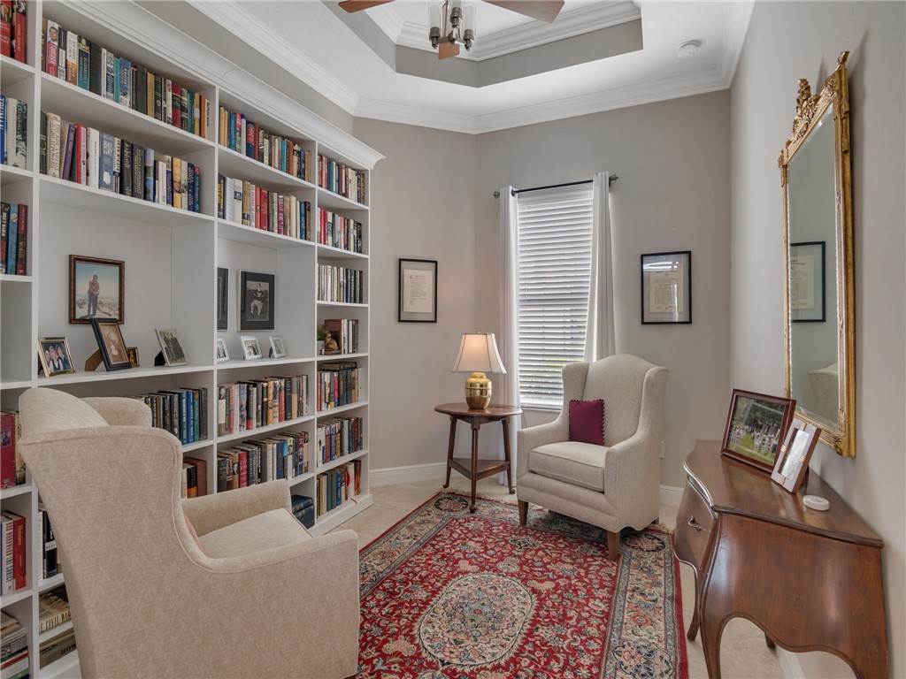 8260 Halbert Lane Vero Beach, FL 32968 - Photo 20 of 36 a living room with furniture and a book shelf
