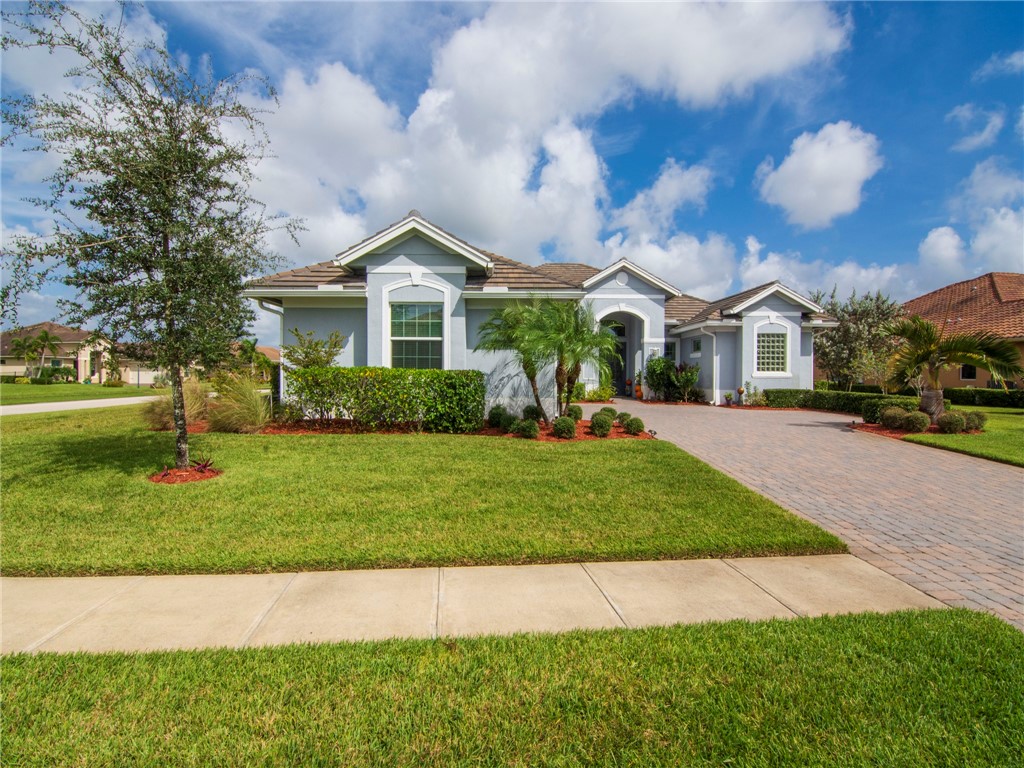 8260 Halbert Lane Vero Beach, FL 32968 - Photo 2 of 36 a front view of a house with a yard