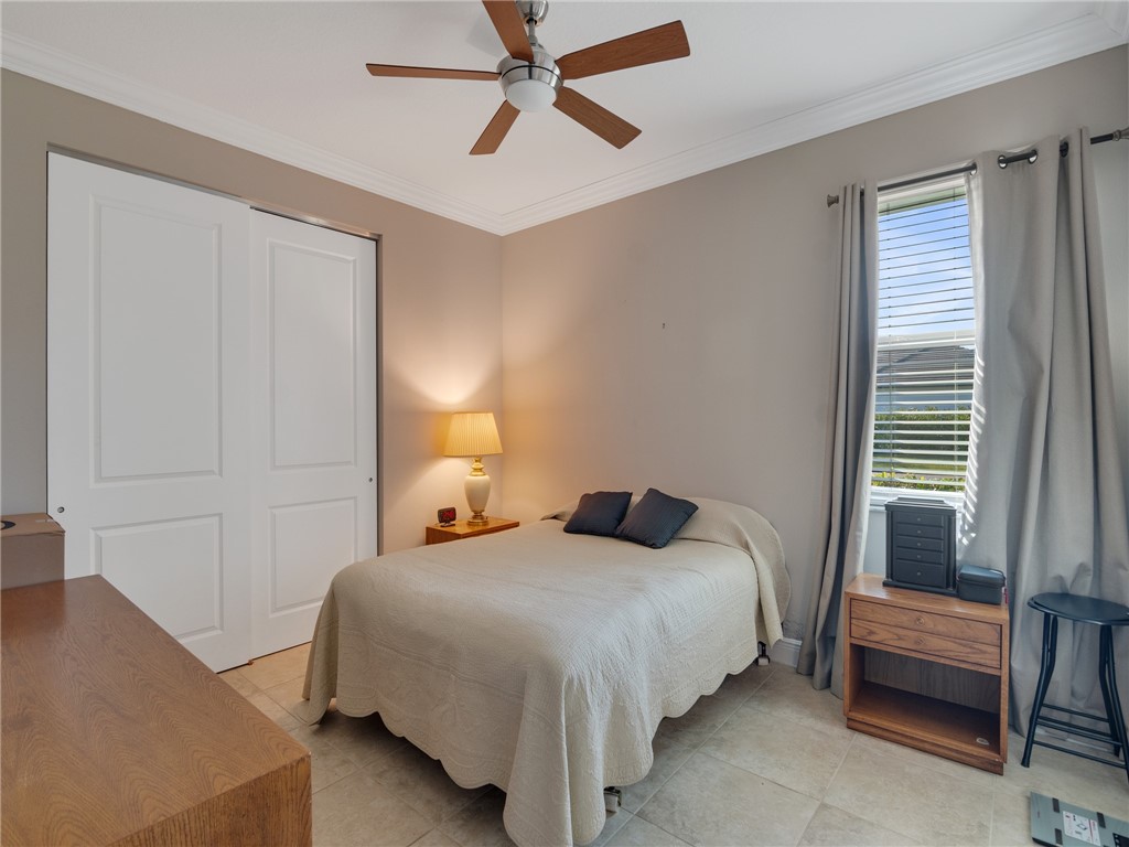 8260 Halbert Lane Vero Beach, FL 32968 - Photo 21 of 36 a bedroom with a bed and a chandelier