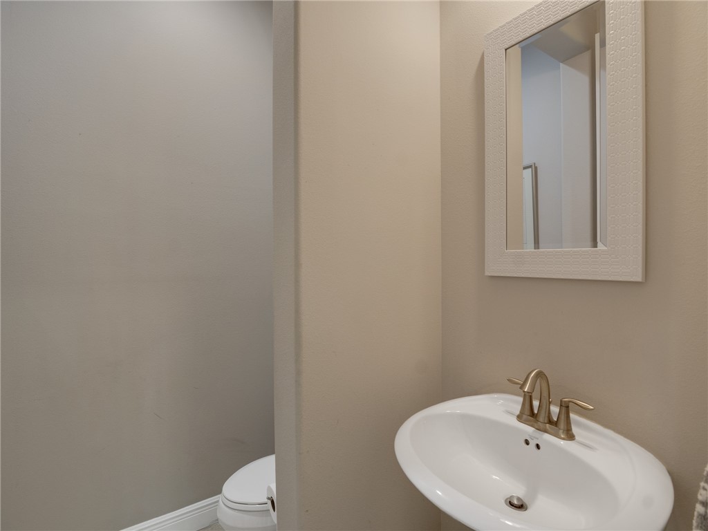 8260 Halbert Lane Vero Beach, FL 32968 - Photo 22 of 36 a bathroom with a sink a toilet and mirror