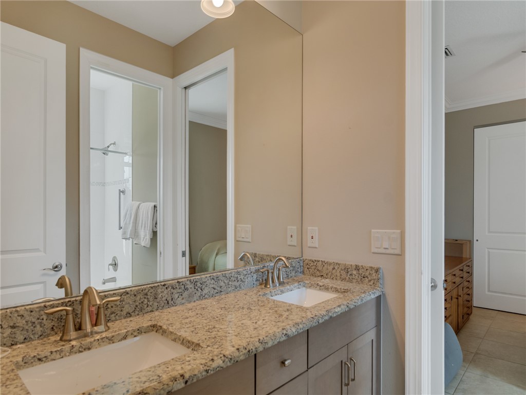 8260 Halbert Lane Vero Beach, FL 32968 - Photo 24 of 36 a bathroom with a granite countertop sink and a mirror