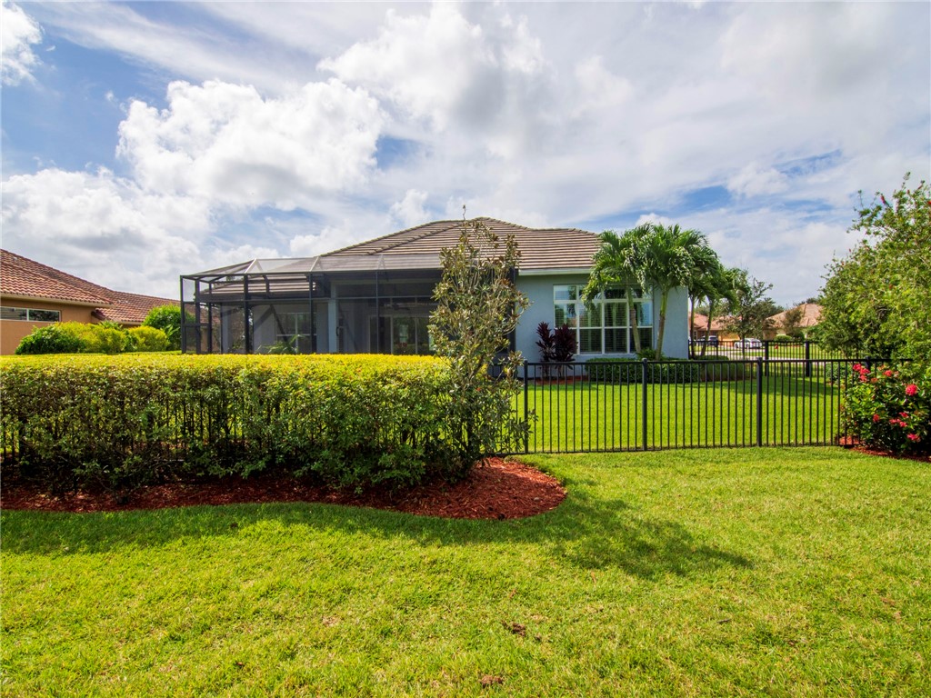 8260 Halbert Lane Vero Beach, FL 32968 - Photo 26 of 36 a view of a backyard with plants and a garden