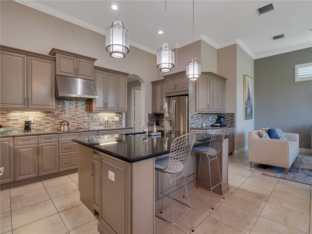 8260 Halbert Lane Vero Beach, FL 32968 - Photo 10 of 36 a kitchen with stainless steel appliances granite countertop a sink a stove and a refrigerator