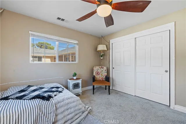 a bathroom with a granite countertop double vanity sink and a mirror