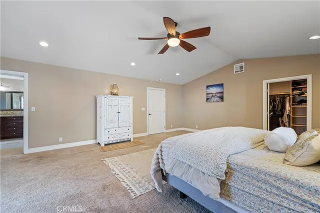a spacious bedroom with a bed and a chandelier