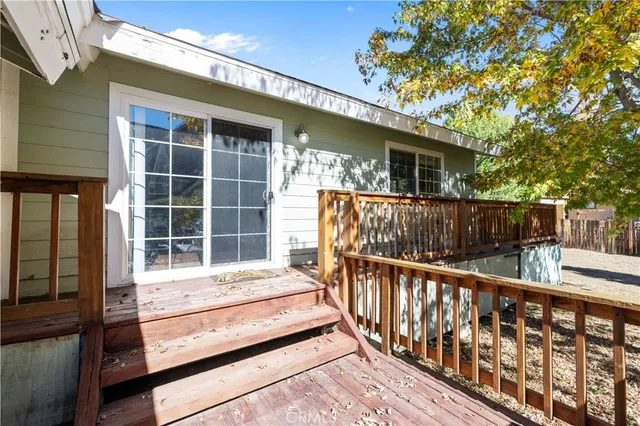 a balcony with wooden floor and fence