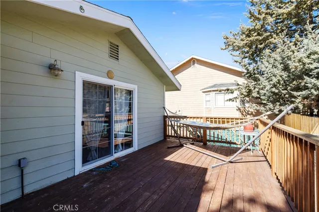 a front view of a house with a yard covered in snow