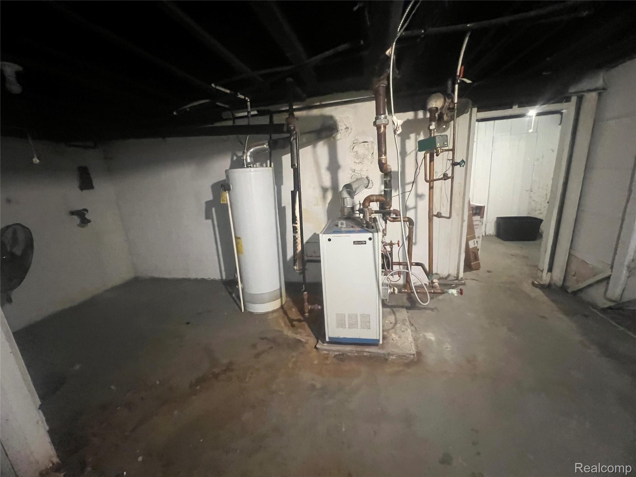 17311 Santa Rosa Drive Detroit, MI 48221 - Photo 53 of 89 Utility room featuring a water heater, boiler system, exposed copper piping, painted concrete floor, and painted block walls