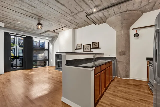 a kitchen with stainless steel appliances granite countertop a stove and a refrigerator