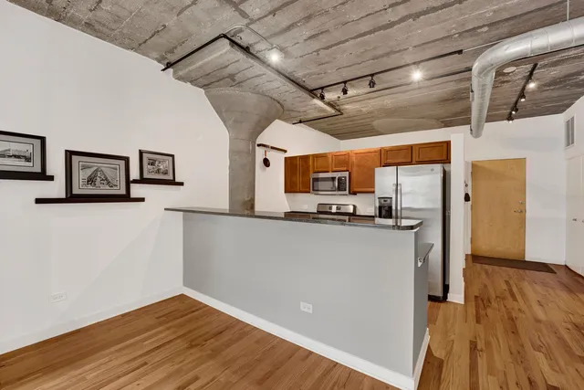 a view of a living room with wooden floor