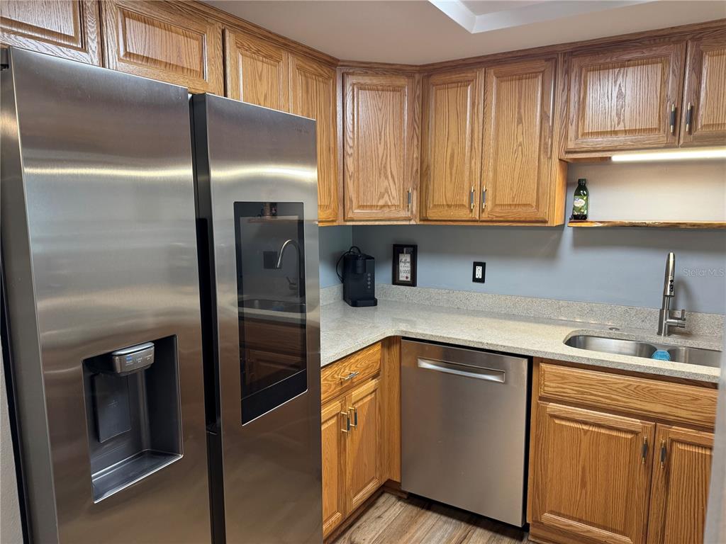 1775 Cupecoy Circle, Unit 4 Lutz, FL 33558 - Photo 13 of 33 a kitchen with a refrigerator sink and cabinets
