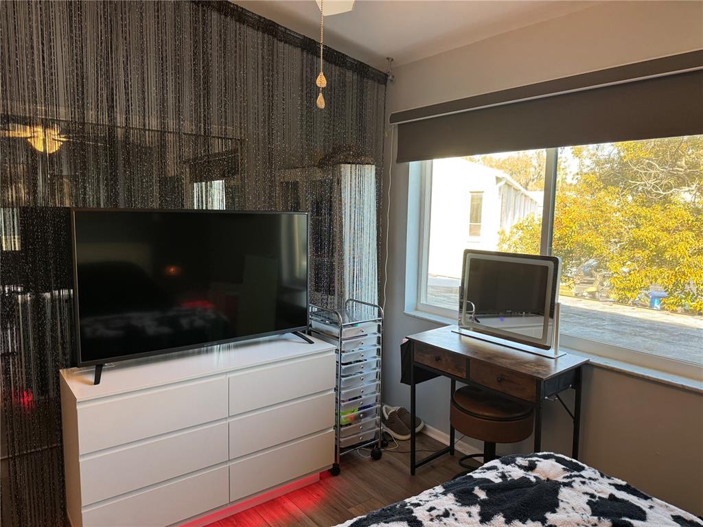 1775 Cupecoy Circle, Unit 4 Lutz, FL 33558 - Photo 19 of 33 a room with a chair and a flat screen tv