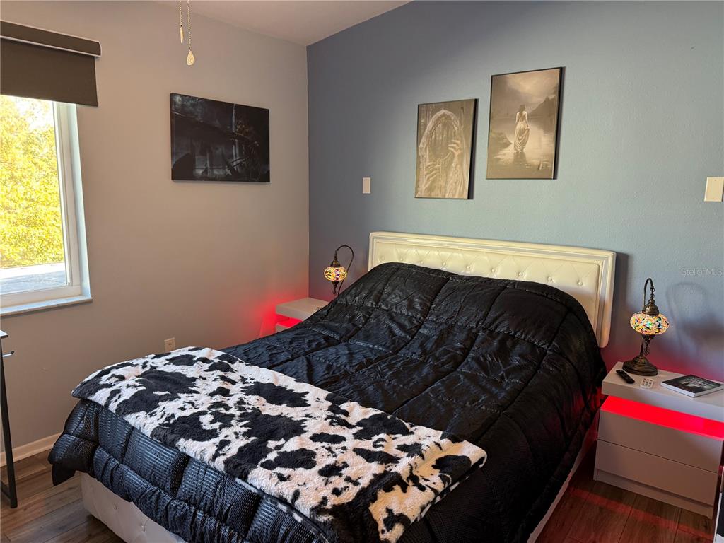 1775 Cupecoy Circle, Unit 4 Lutz, FL 33558 - Photo 21 of 33 a bedroom with a bed and a window