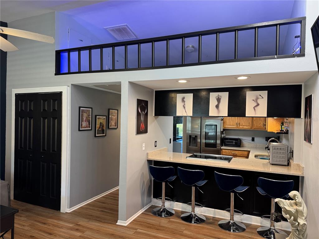 1775 Cupecoy Circle, Unit 4 Lutz, FL 33558 - Photo 9 of 33 a living room with a wooden floor