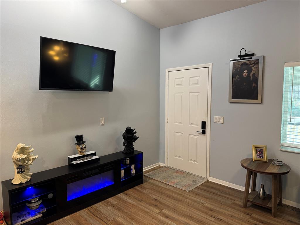 1775 Cupecoy Circle, Unit 4 Lutz, FL 33558 - Photo 10 of 33 a living room with furniture and a flat screen tv